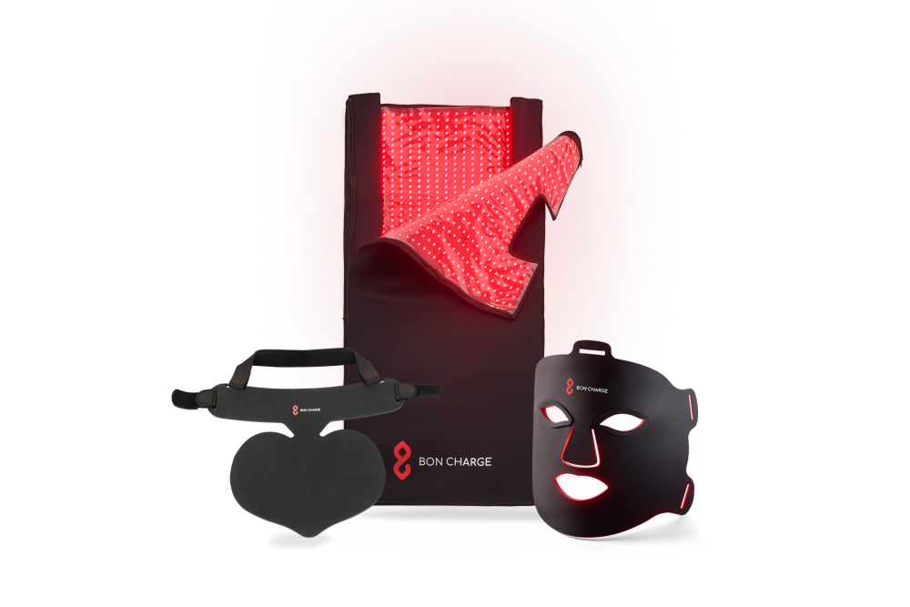 Red light face mask, next to a red light neck and chest mask with a red light blanket above un-zipped glowing red